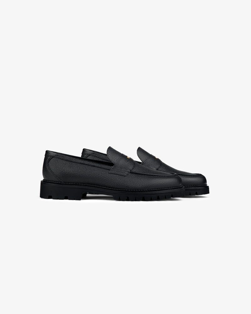 Lug Sole Queens Crest Loafer in black textured leather with chunky soles on a plain light background.
