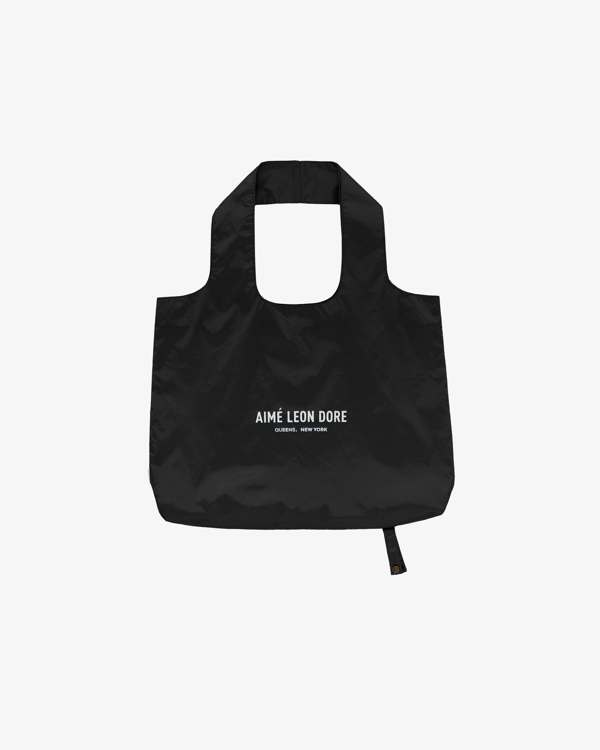 Black Packable Logo Tote with AIMÉ LEON DORE CLOTHIER, NEW YORK printed in white on the front.