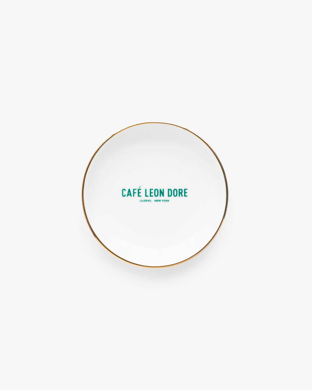 Café Leon Dore Ring Dish: white plate with gold rim, green CAFÉ LEON DORE label at center, on white background.