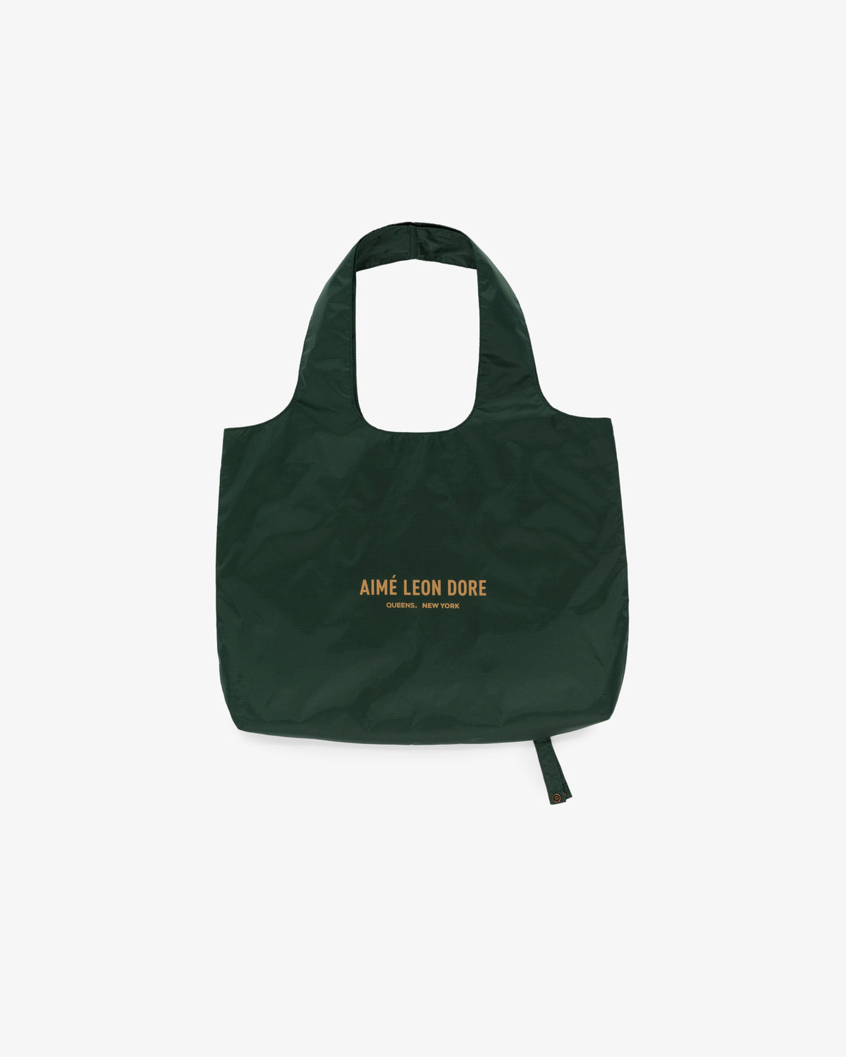 Dark green Packable Tote with AIMÉ LEON DORE and yellow text centered on front, shown against a white background.
