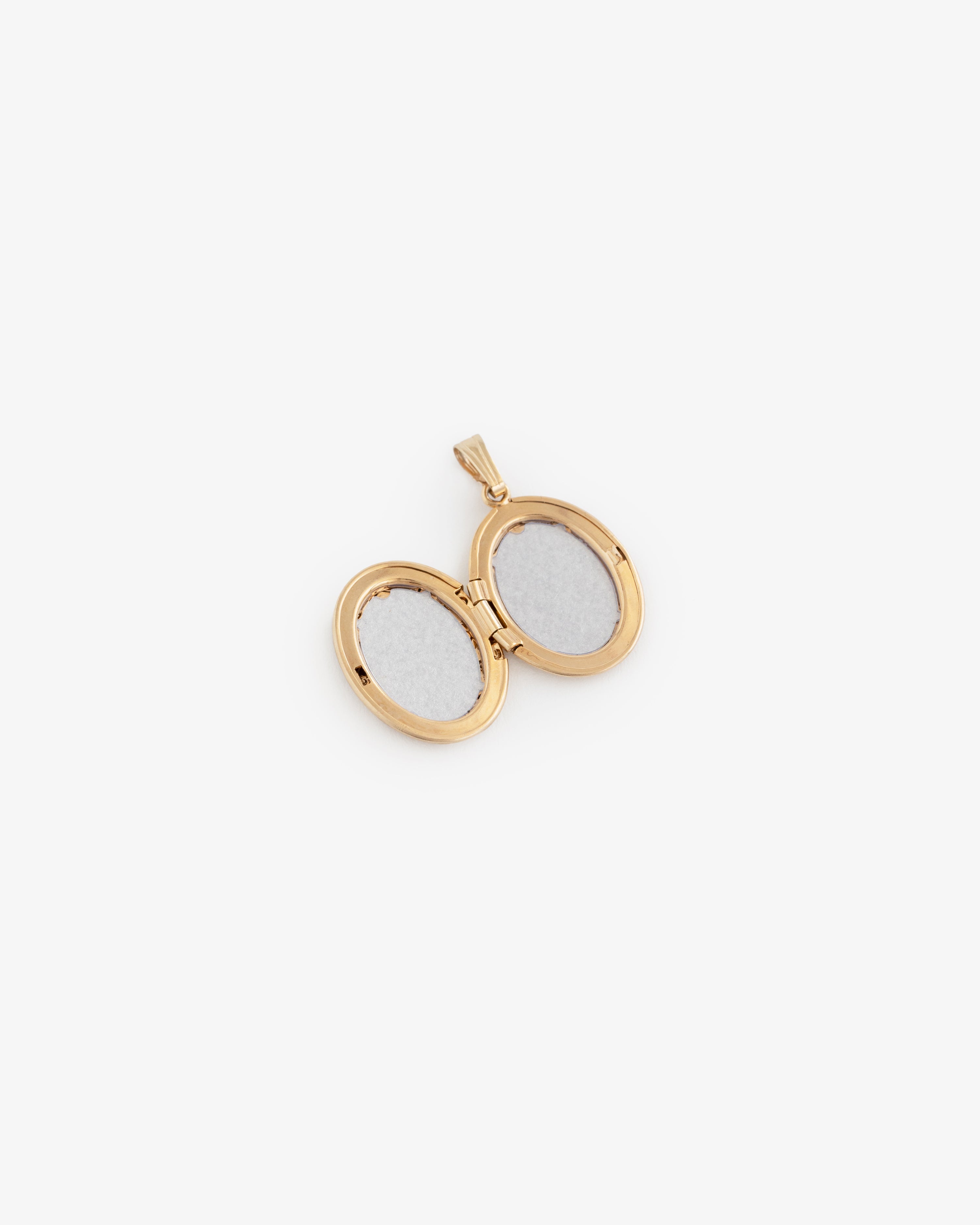 14Kt Gold oval locket pendant opens to reveal two photo spaces, displayed on a white background.