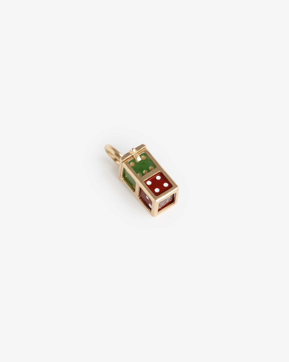 A 14Kt gold Lucky Dice pendant with green and red enamel accents and white dots on the red side.