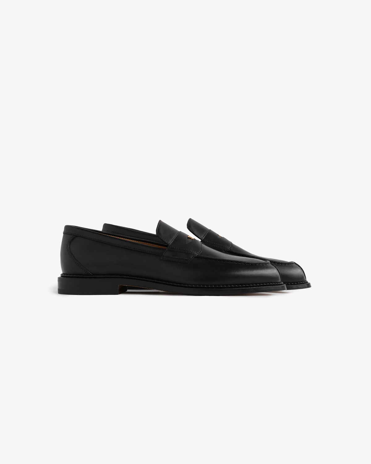 Queens Crest Loafer in black leather with low heels, shown in profile on a plain white background.