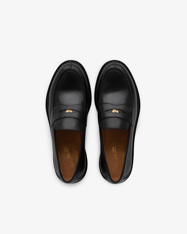 Queens Crest Loafer: black leather with gold bee detail, top view on a white background.