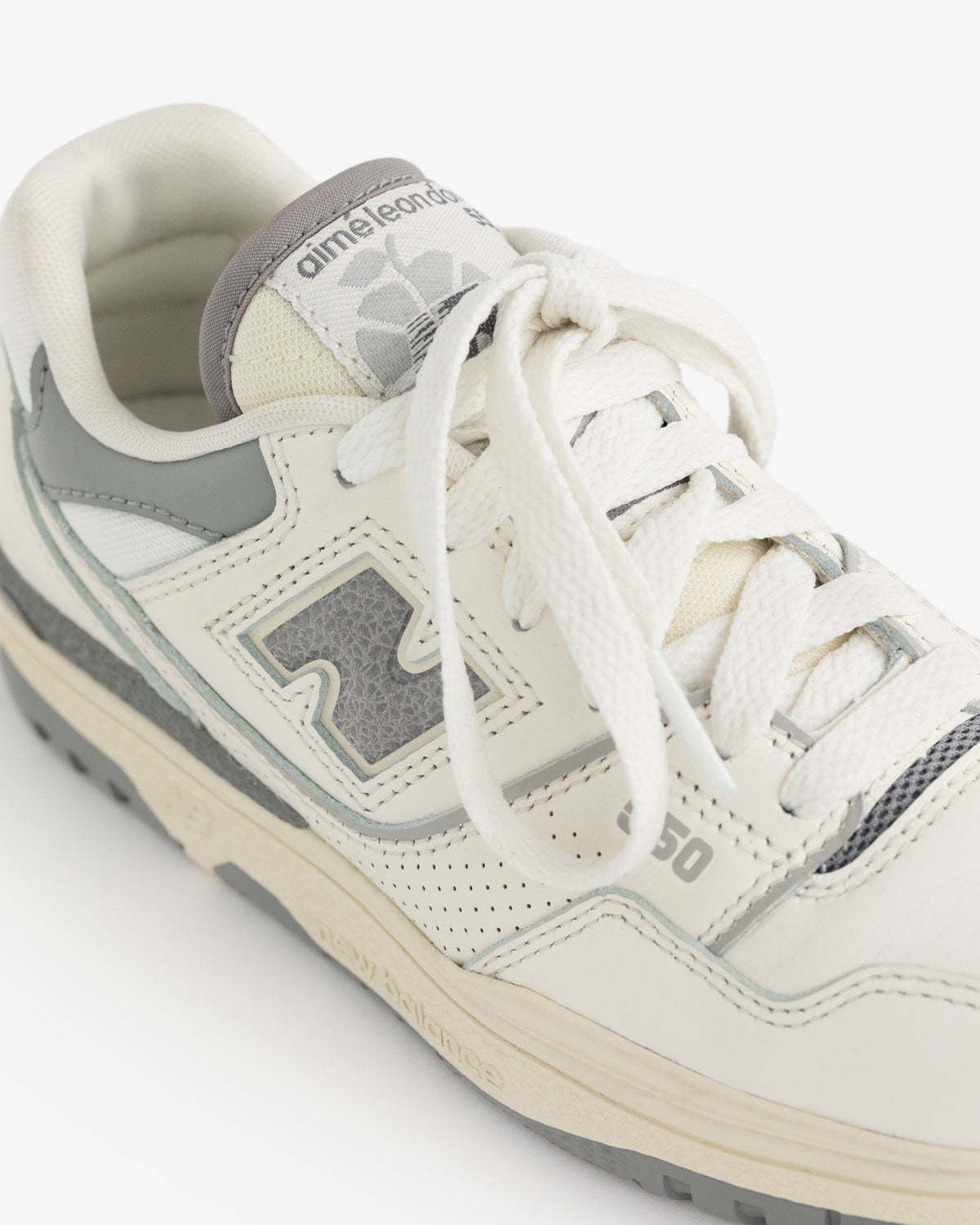 The ALD / NB P550 Basketball Oxfords - Little Kids are white with gray accents and Aimé Leon Dore branding on the tongue.