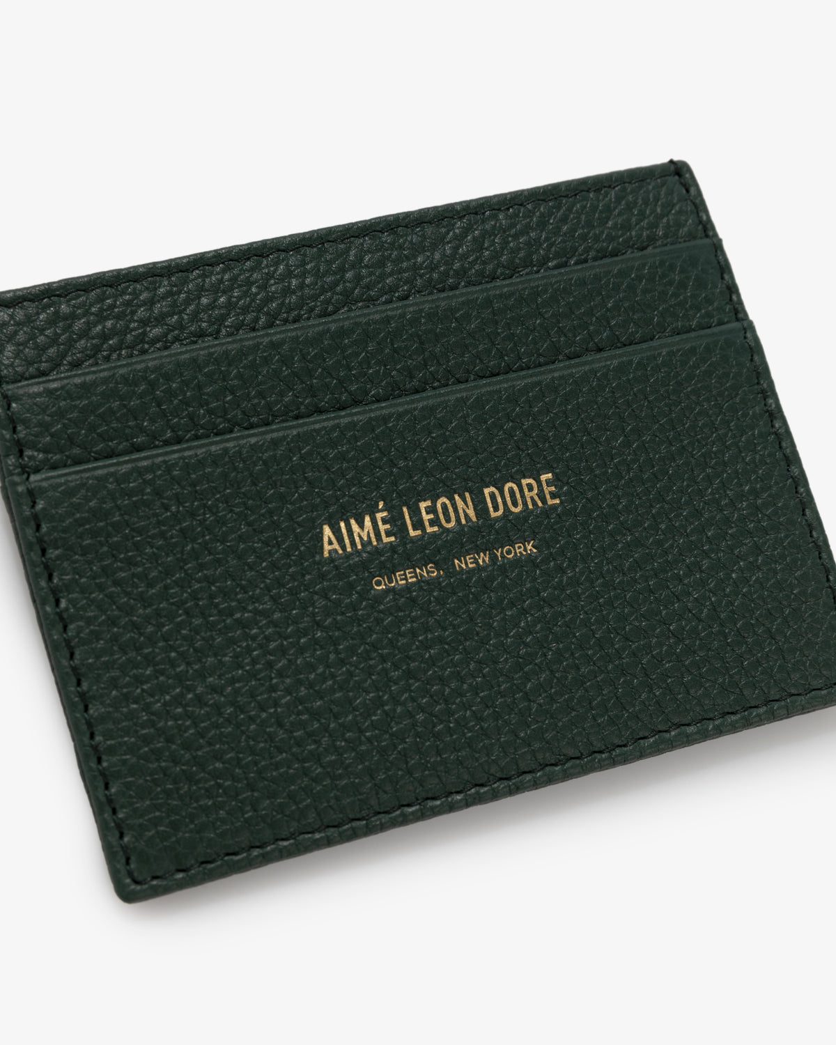 Leather Card Holder in dark green textured leather with gold AIMÉ LEON DORE QUEENS, NEW YORK text on front.