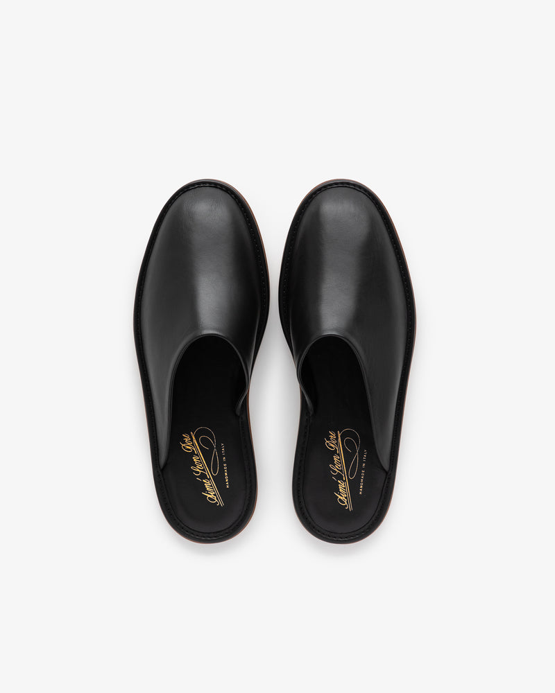 A pair of Leather Travel Slippers in black leather slip-on style, viewed from above on a white background.