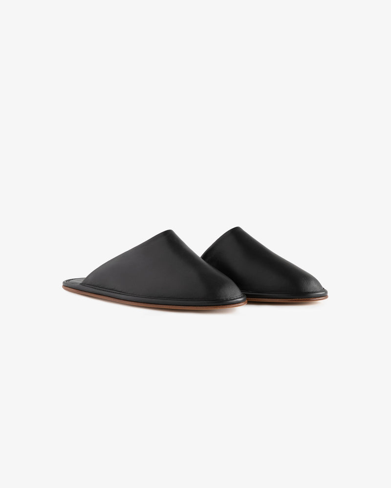 A pair of Leather Travel Slippers in black with brown soles, shown on a white background.
