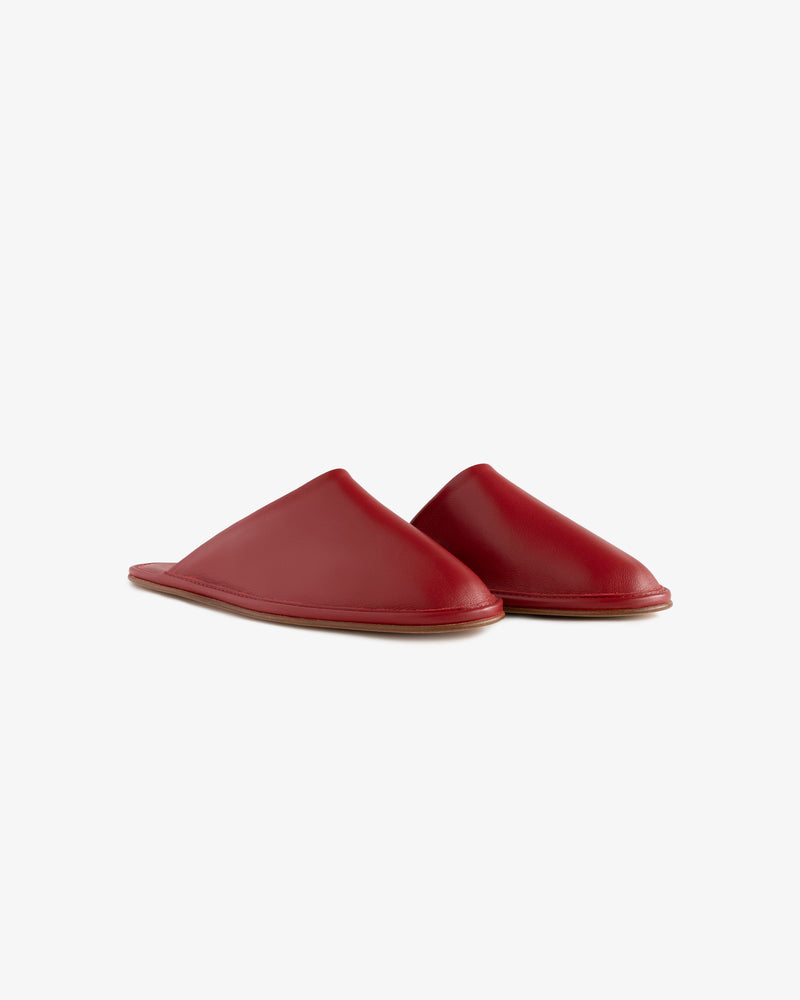 Leather Travel Slipper: a pair of red slip-on leather slippers with flat soles on a plain white background.