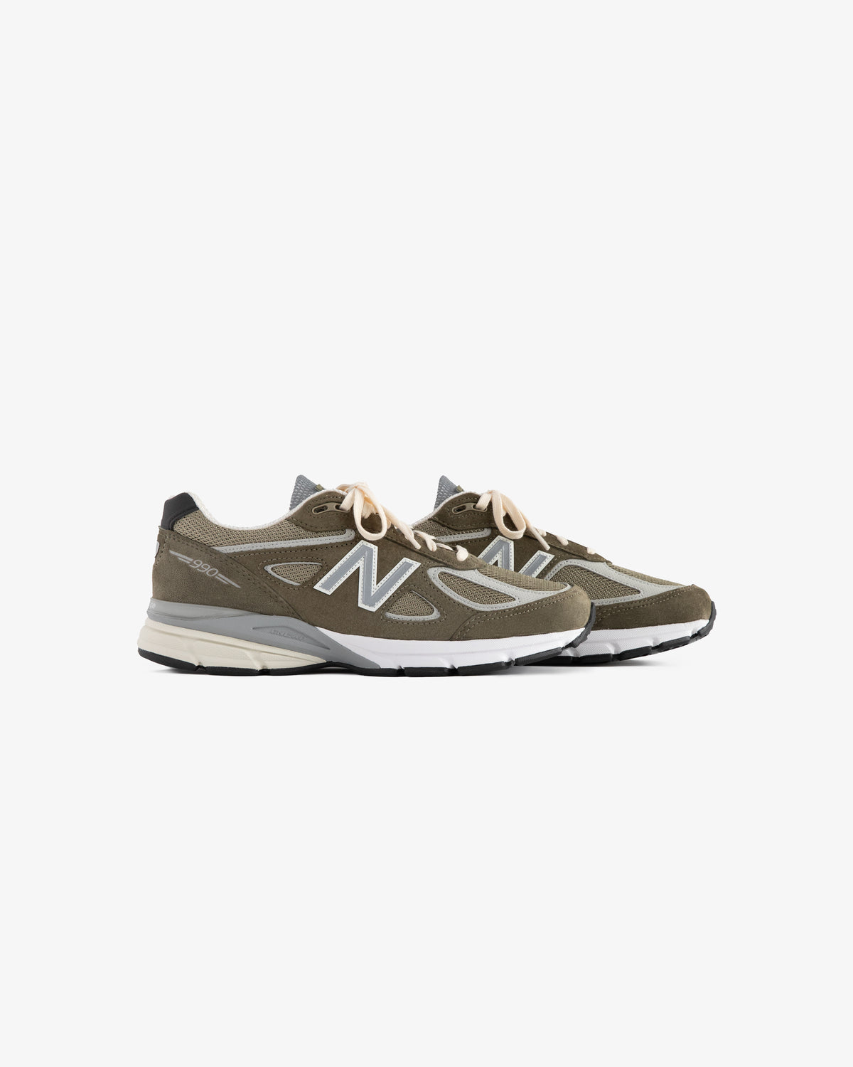 A pair of ALD / New Balance 990v4 olive green sneakers with white midsoles and beige laces on a white background.
