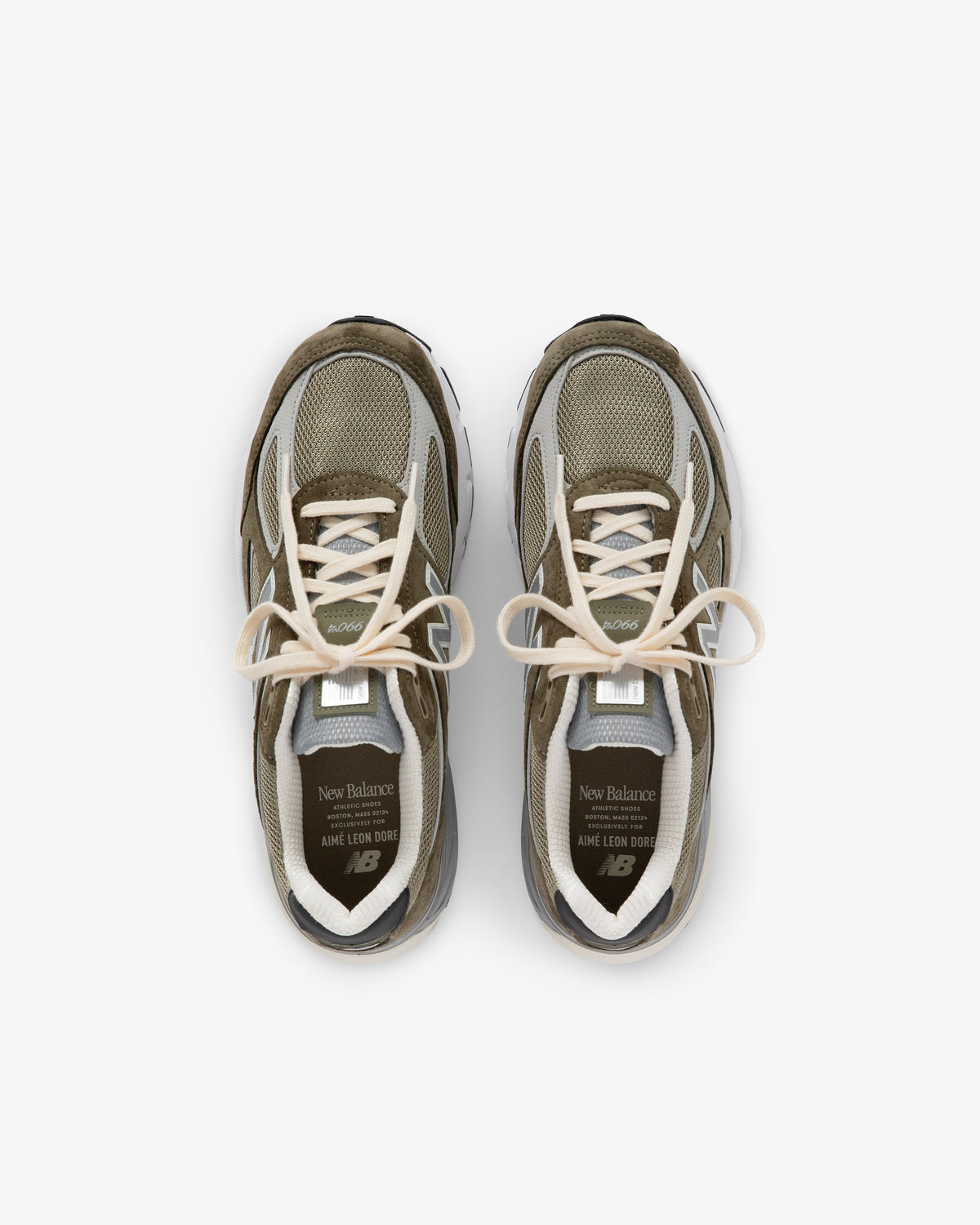 A pair of olive green and beige ALD / New Balance 990v4 sneakers viewed from above on a white background.