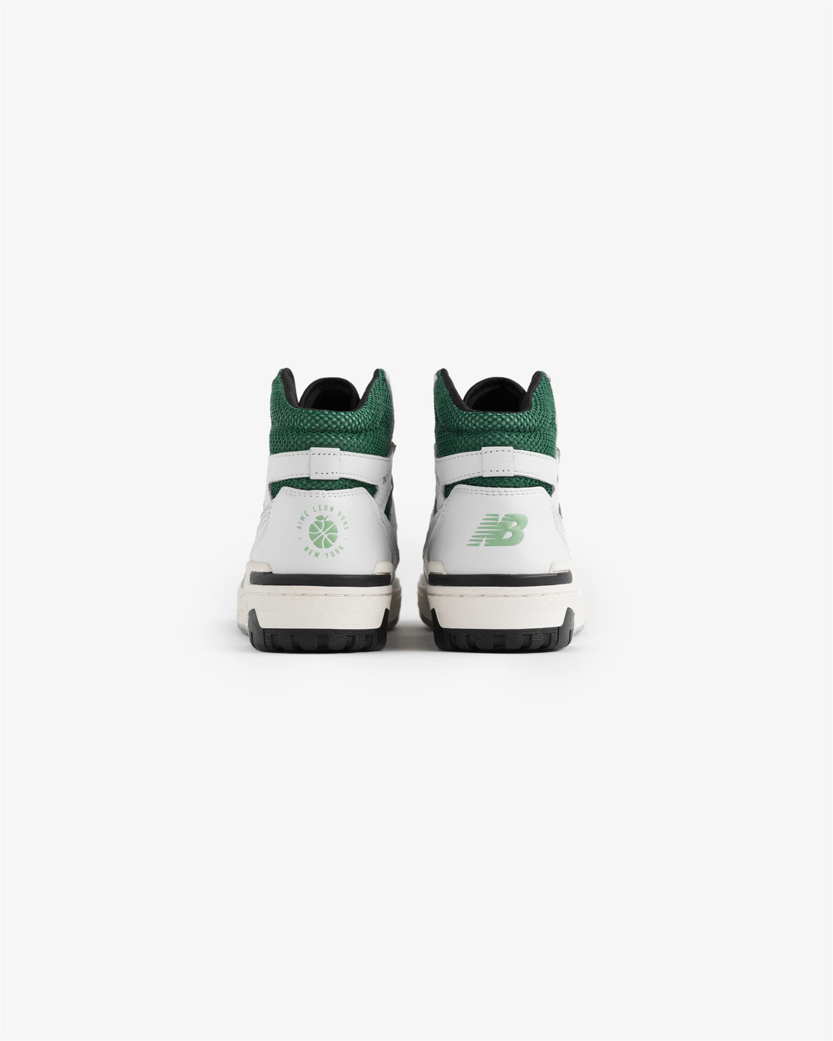 ALD / New Balance 650R sneakers in white and green, viewed from the back on a plain white background.