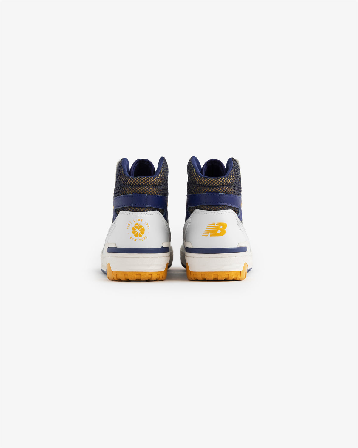 ALD / New Balance 650R sneakers viewed from the back, in blue, white, and yellow on a white background.