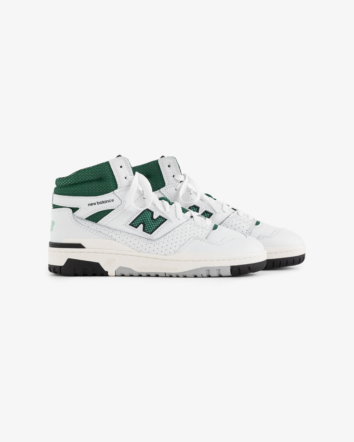 Pair of white and green ALD / New Balance 650R sneakers with black soles on a plain white background.