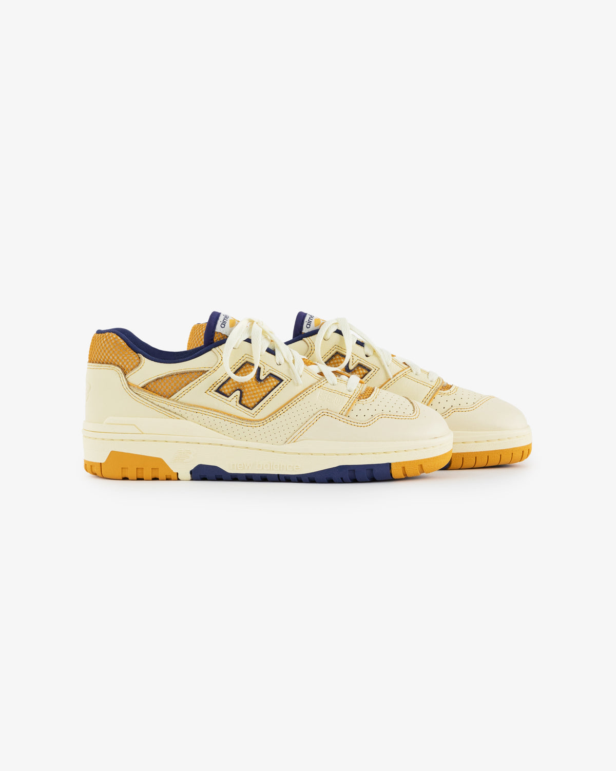 ALD / NB P550 Basketball Oxfords: cream and yellow low-tops with navy, mesh panels, and orange rubber soles.