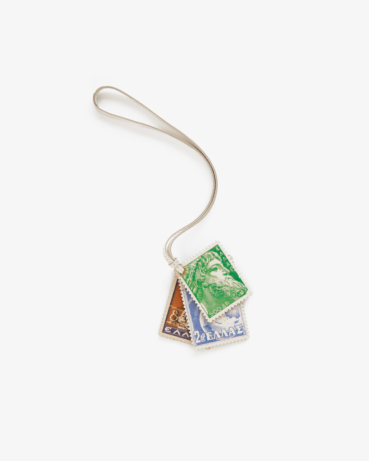 The Leather Traveler Charm is a keychain featuring three Greek postage stamp charms in green, orange, and blue.