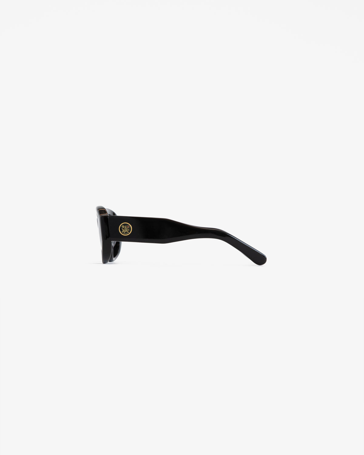 Jackie O Sunglasses in black, shown from the side with a gold circular emblem on the arm against a white background.