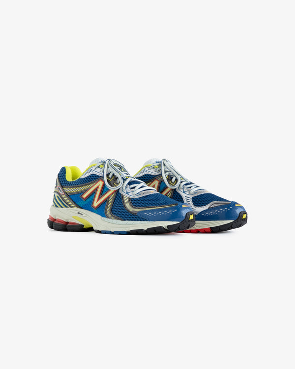 Women's Sneaker Test: blue sneakers with yellow, orange, and red accents shown on a white background.