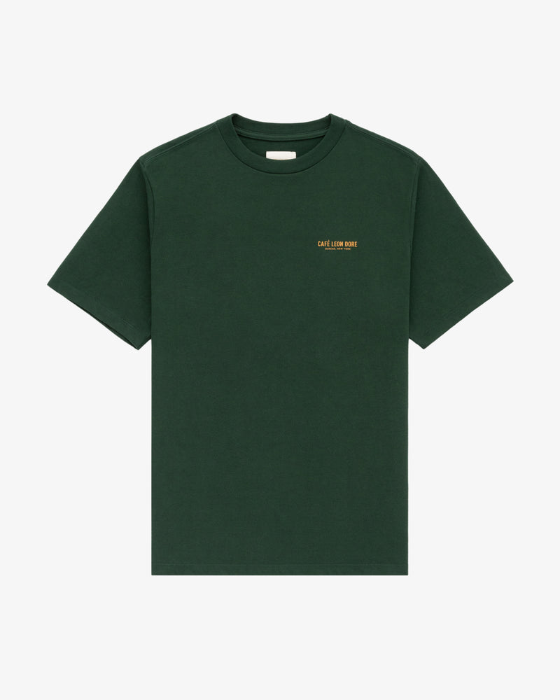 Dark green Café Leon Dore Logo Tee with small yellow text on left chest, shown on a white background.