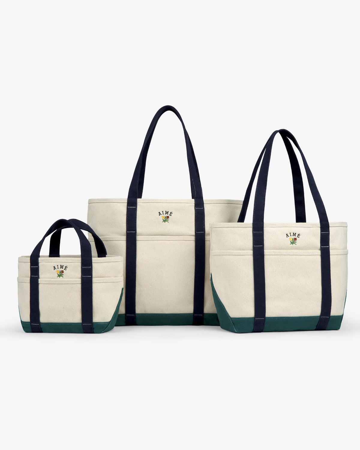 Large Crest Contrast Tote Bag with navy handles and green base, displayed on a white background.