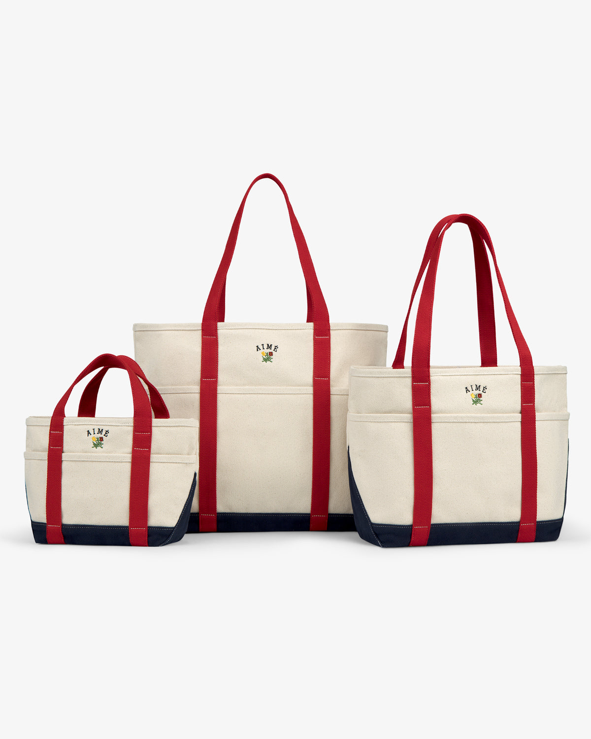 Three Mini Crest Contrast Tote Bags in various sizes with red handles, navy bottoms, and embroidered logos.