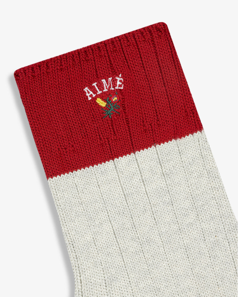 Crest Varsity Sock: Red and white ribbed with AIMÉ lettering and small embroidered flower near the top.