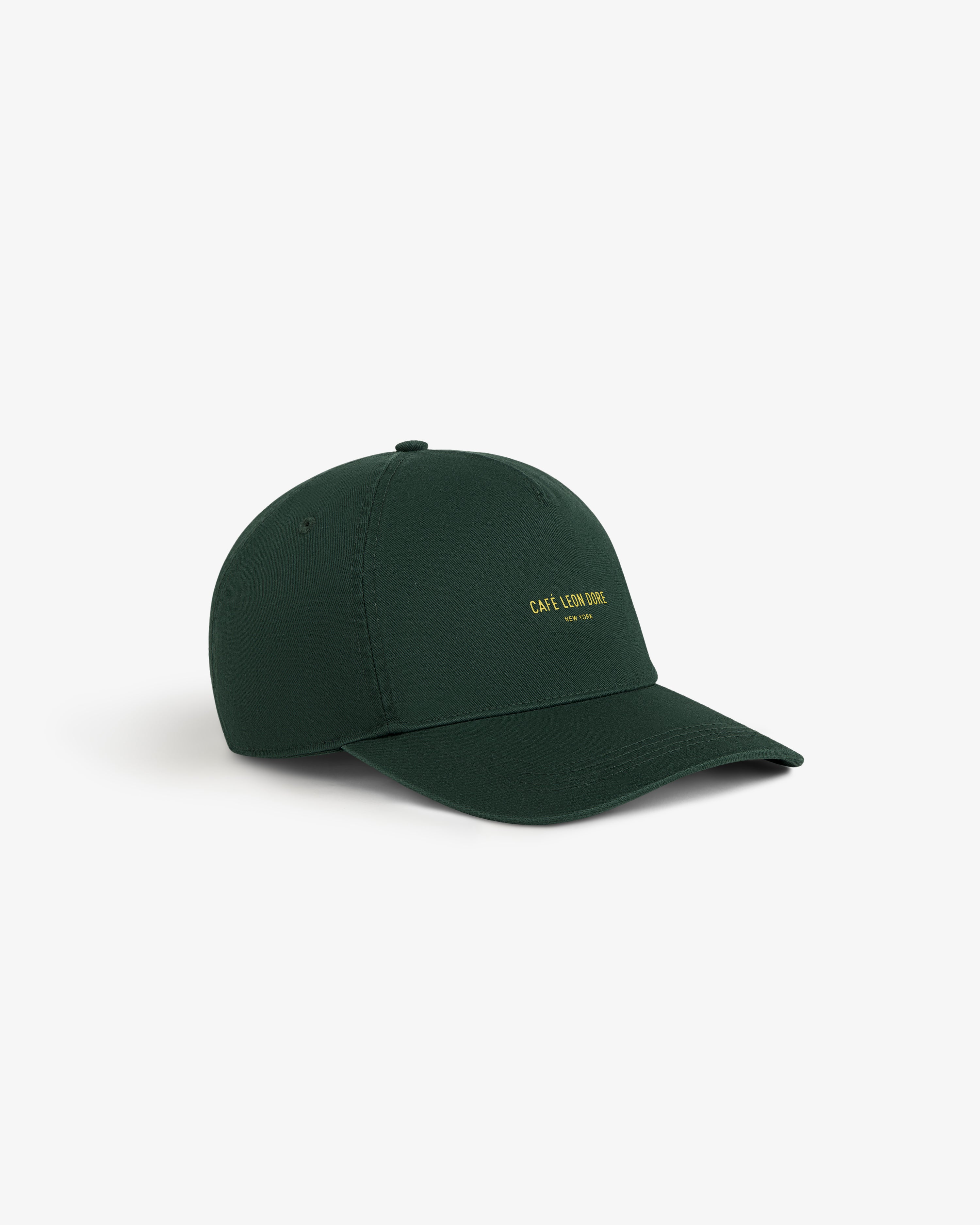 Café Leon Dore Logo Hat in dark green with yellow text, shown on a white background.