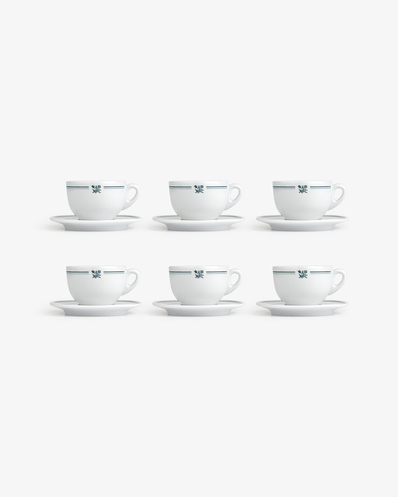 Set of 6 Café Leon Dore cappuccino cups with saucers, white with blue pattern, arranged in two rows on white background.