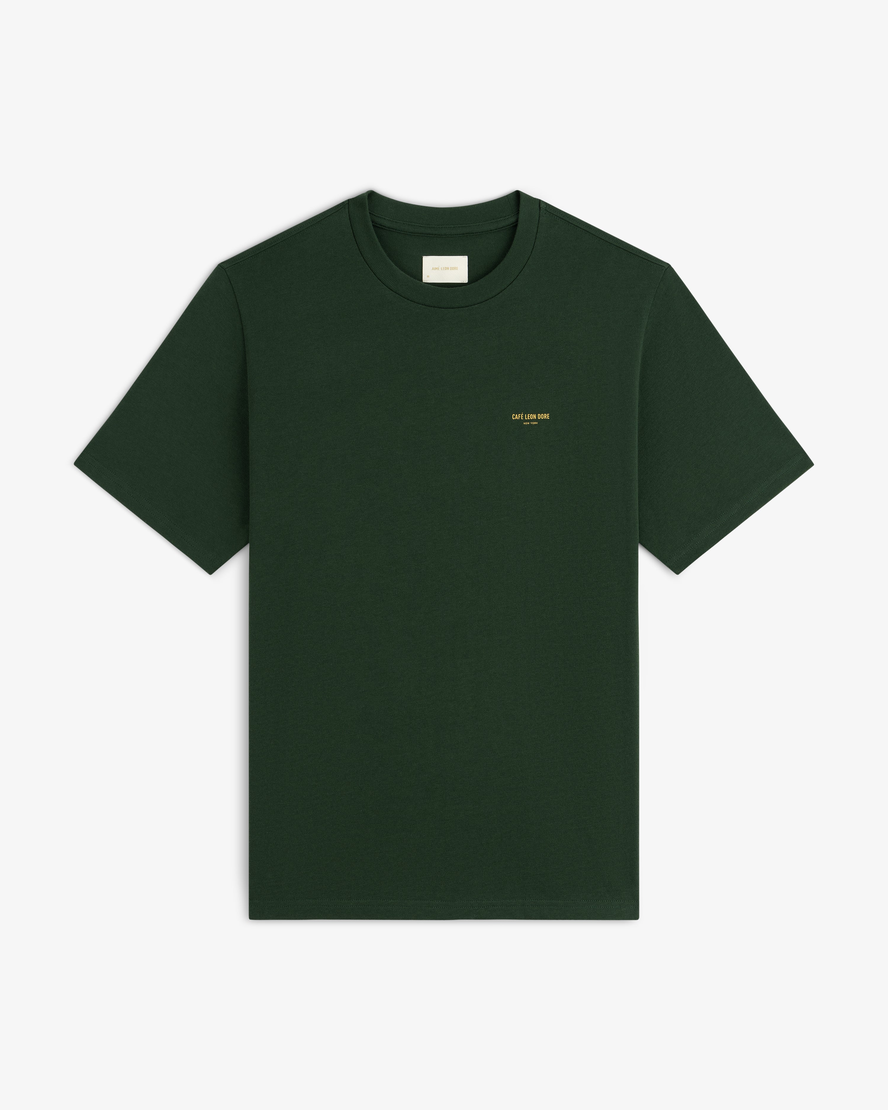 Café Leon Dore Logo Tee: dark green, short sleeves, small yellow chest text, shown on white background.
