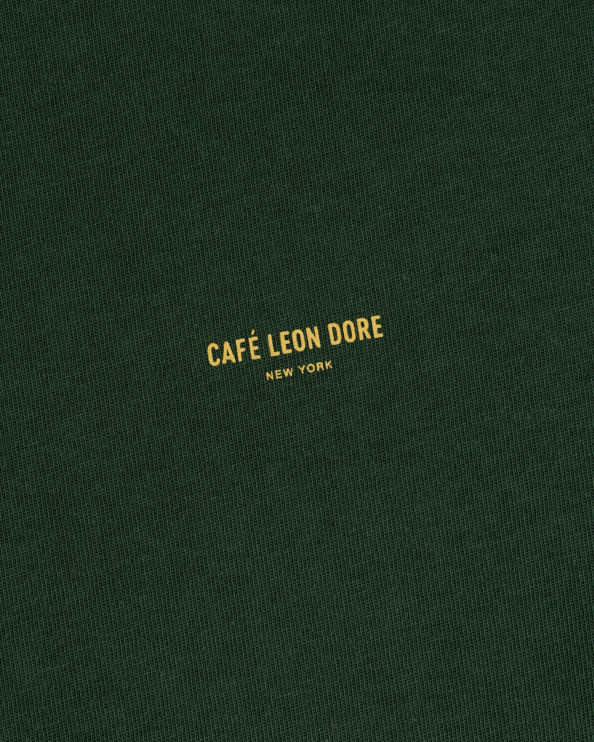Dark green Café Leon Dore Logo Tee with small yellow “CAFÉ LEON DORE NEW YORK” printed at the center.