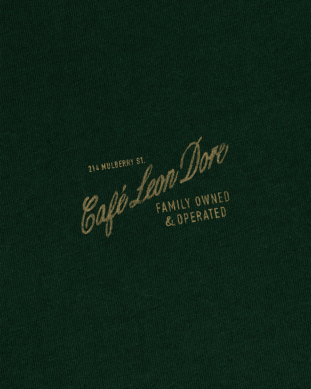 Green Café Leon Dore Mulberry Tee—yellow “214 Mulberry St. Family Owned & Operated” text on front.