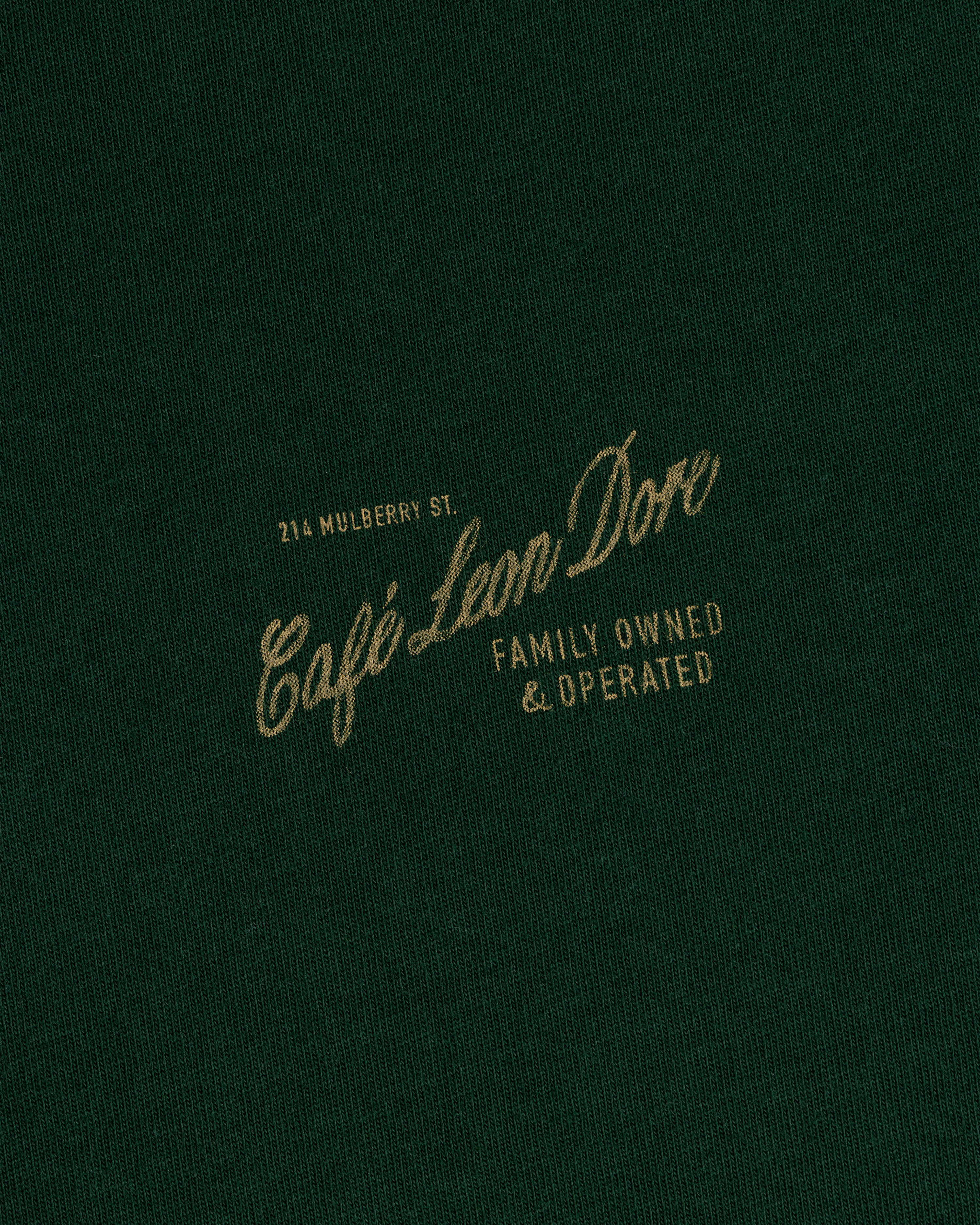 Green Café Leon Dore Mulberry Tee—yellow “214 Mulberry St. Family Owned & Operated” text on front.
