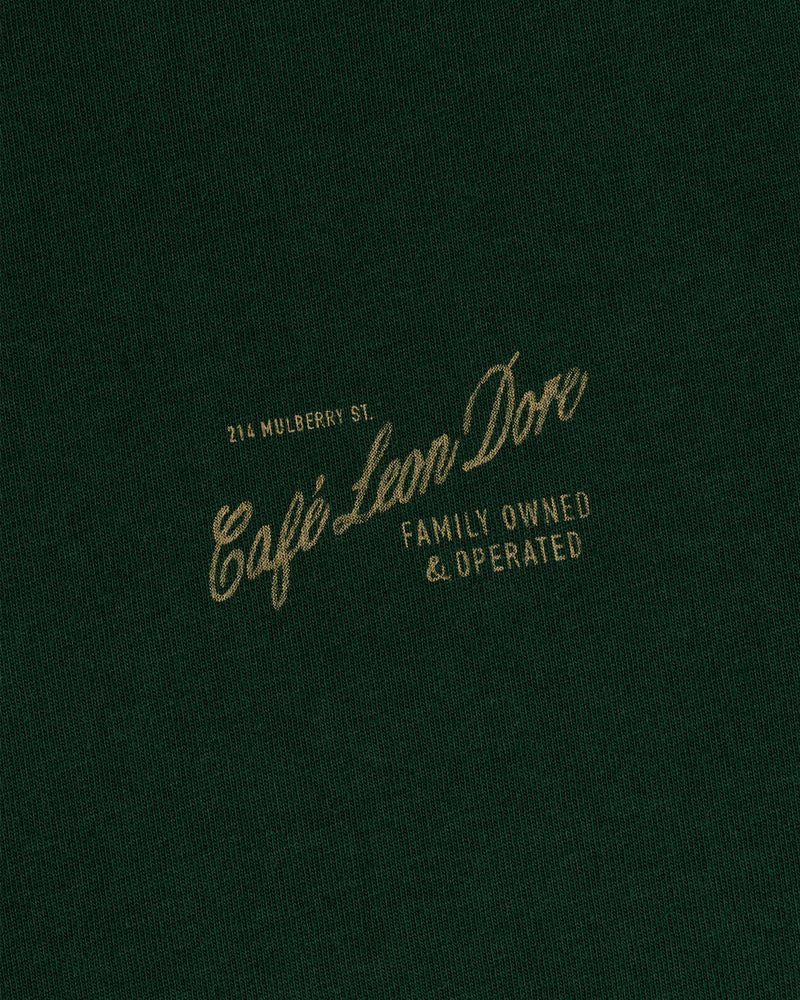 Green Café Leon Dore Mulberry Tee—yellow “214 Mulberry St. Family Owned & Operated” text on front.
