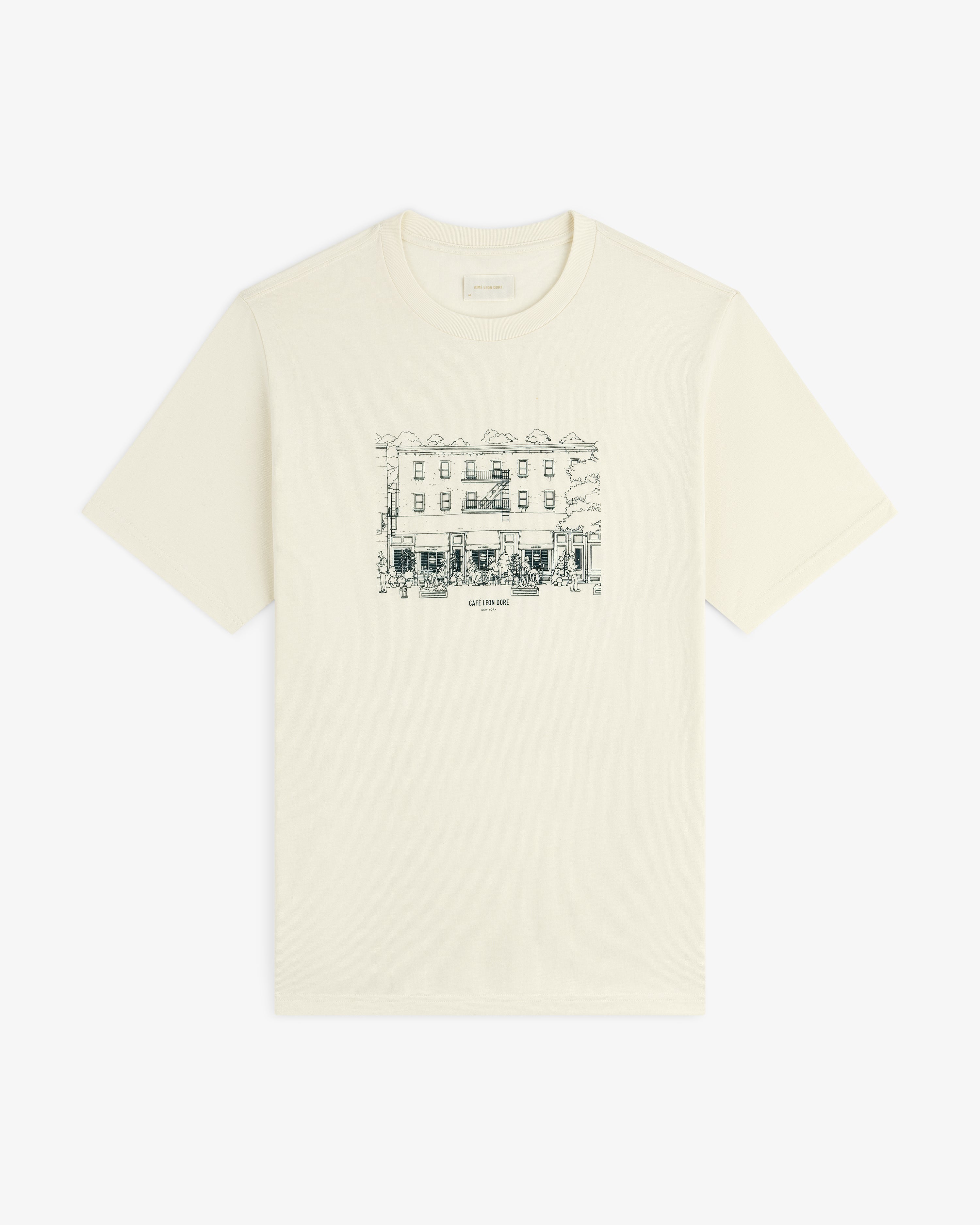 Off-white Café Leon Dore Storefront Tee with line art building and small chest text.