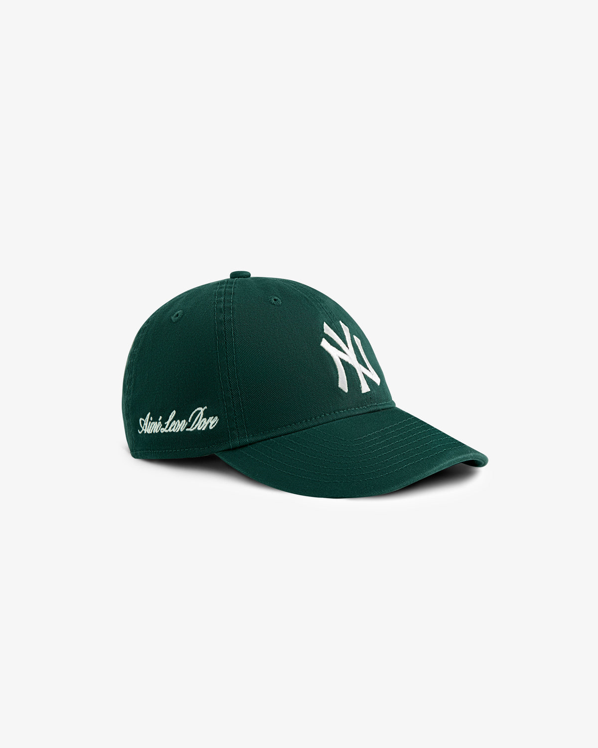 Dark green ALD/New Era Yankees Ballpark Hat with white logo and Saint-Lamar Dore script on the side.