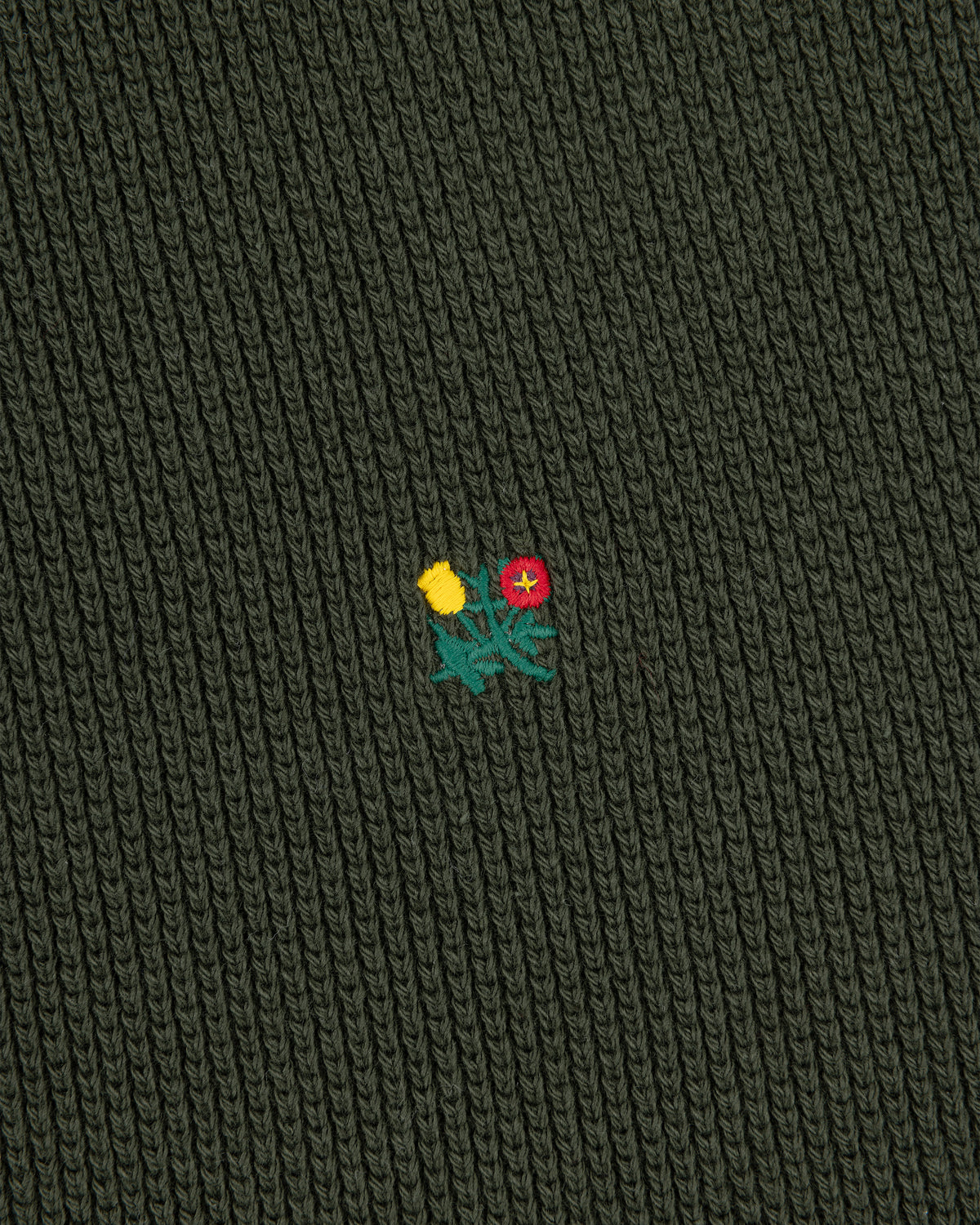 Dark green Crest Piqué Half-Zip Pullover with ribbed fabric, embroidered yellow-red flowers, and green leaves center.