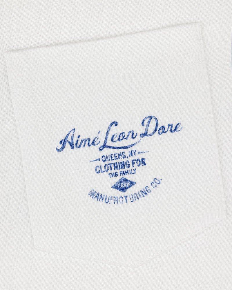 White General Store Pocket Tee with blue text: Aimé Leon Dore, Queens NY, Clothing for the Family, Manufacturing Co.