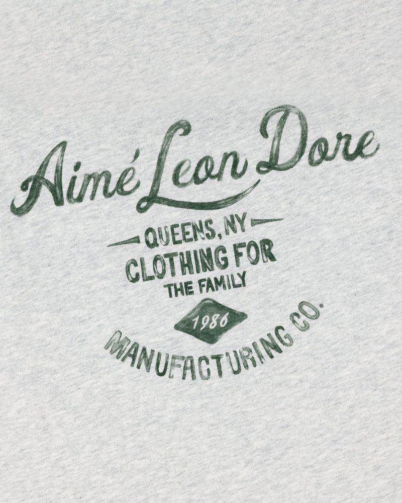 Gray General Store Pocket Tee with green text: Aimé Leon Dore Queens, NY Clothing for the Family 1986 Manufacturing Co.