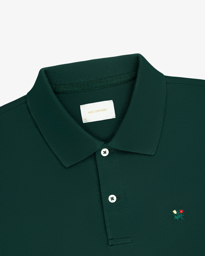 Dark green Long-Sleeve Crest Piqué Polo with collar, two buttons, and a small flower embroidery near the placket.