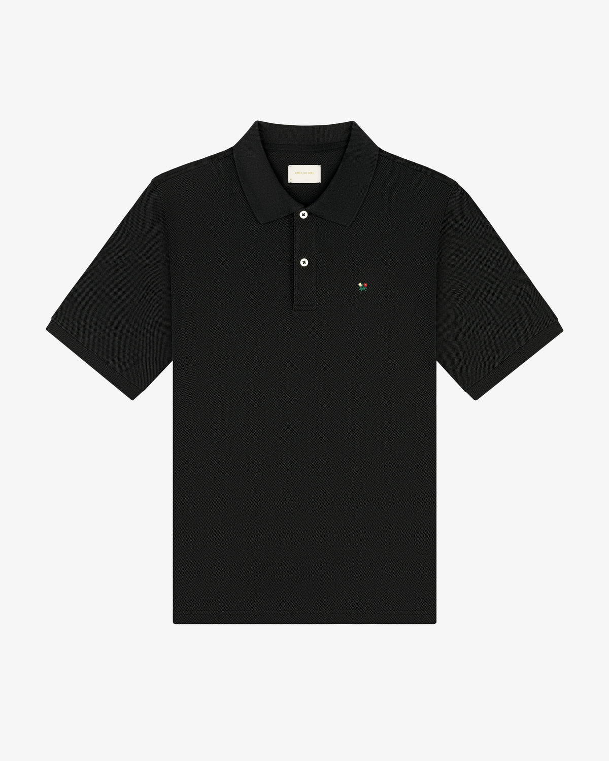 Crest Piqué Polo: black short-sleeve, collared shirt with small chest logo, shown on white background.