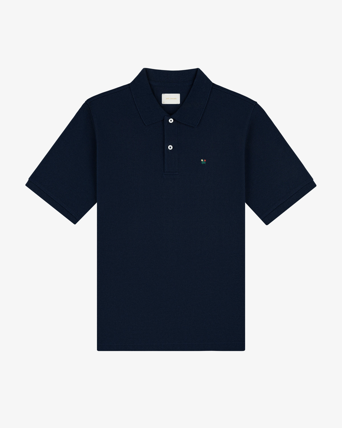 Crest Piqué Polo in navy blue featuring short sleeves, a collar, button placket, and small chest logo on white background.