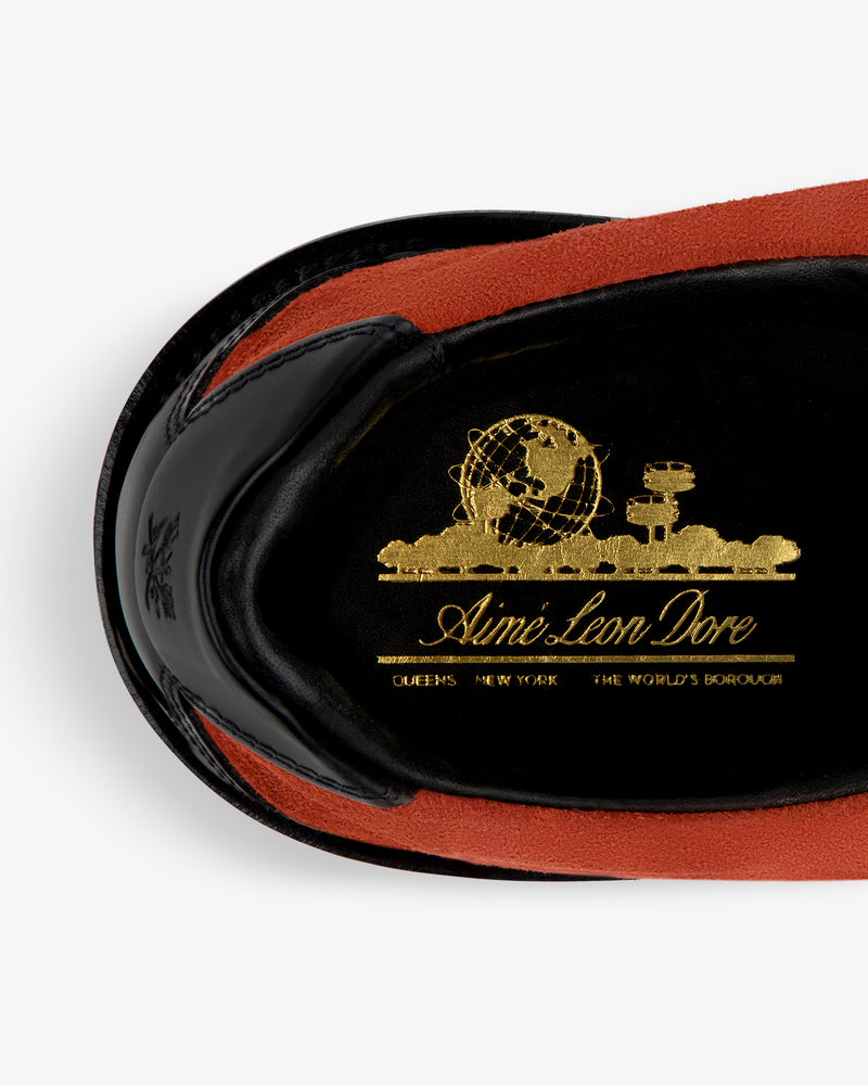 Close-up of Suede Derby Hiker insole with gold globe graphic, Aimé Leon Dore text, and "Queens New York The Worlds Borough.