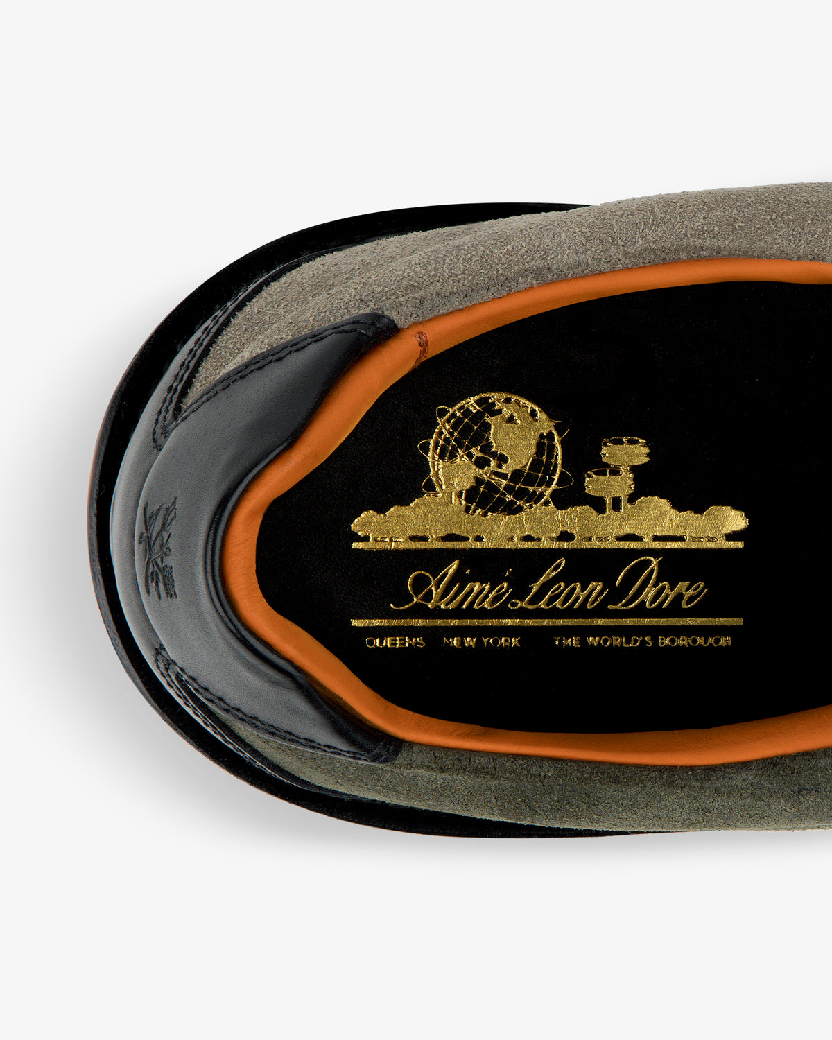 Close-up of Suede Derby Hiker’s insole with gold Aimé Leon Dore branding and orange trim.