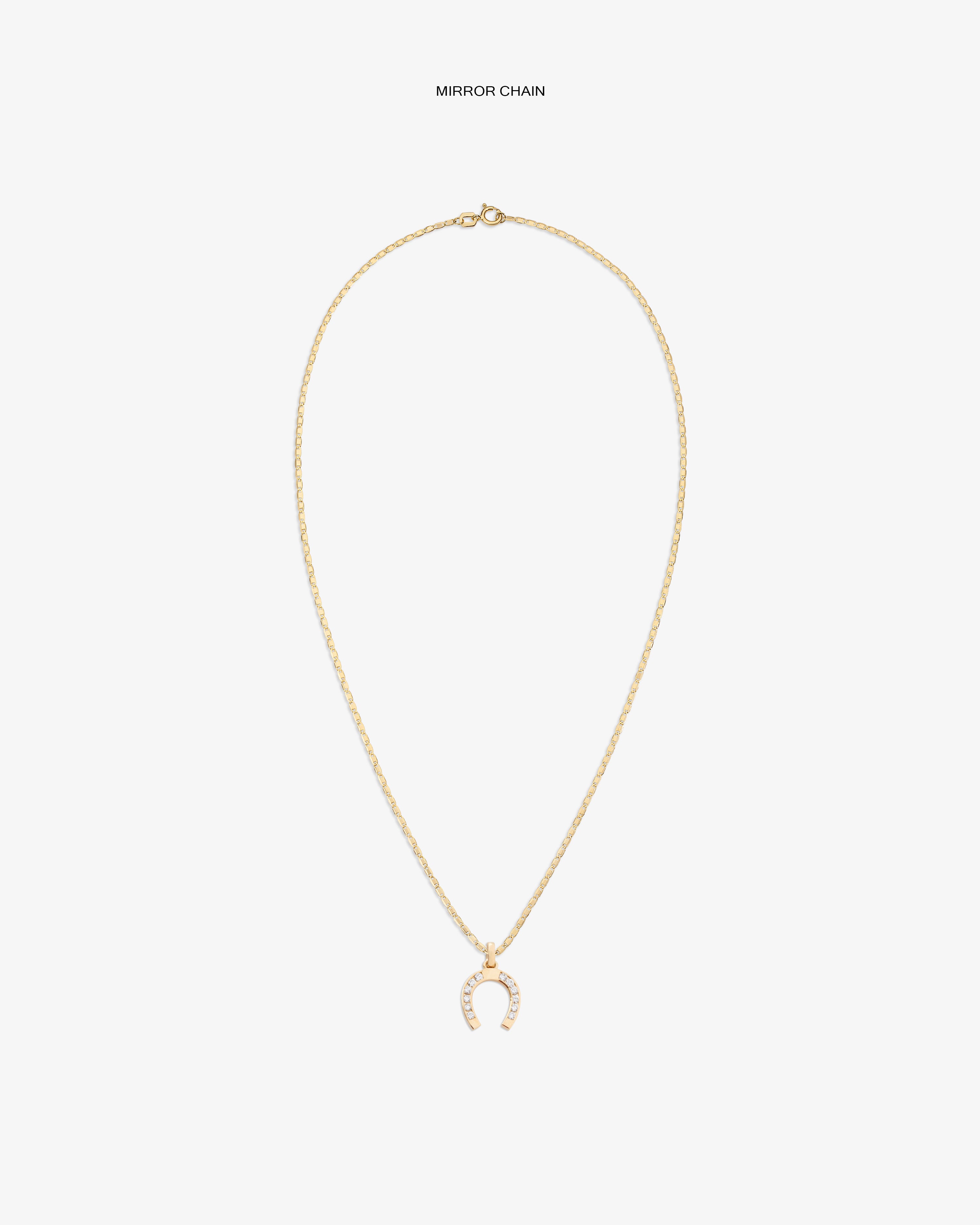 Diamond Horseshoe Pendant: Gold necklace with delicate chain and a pavé horseshoe pendant, shown on white background.