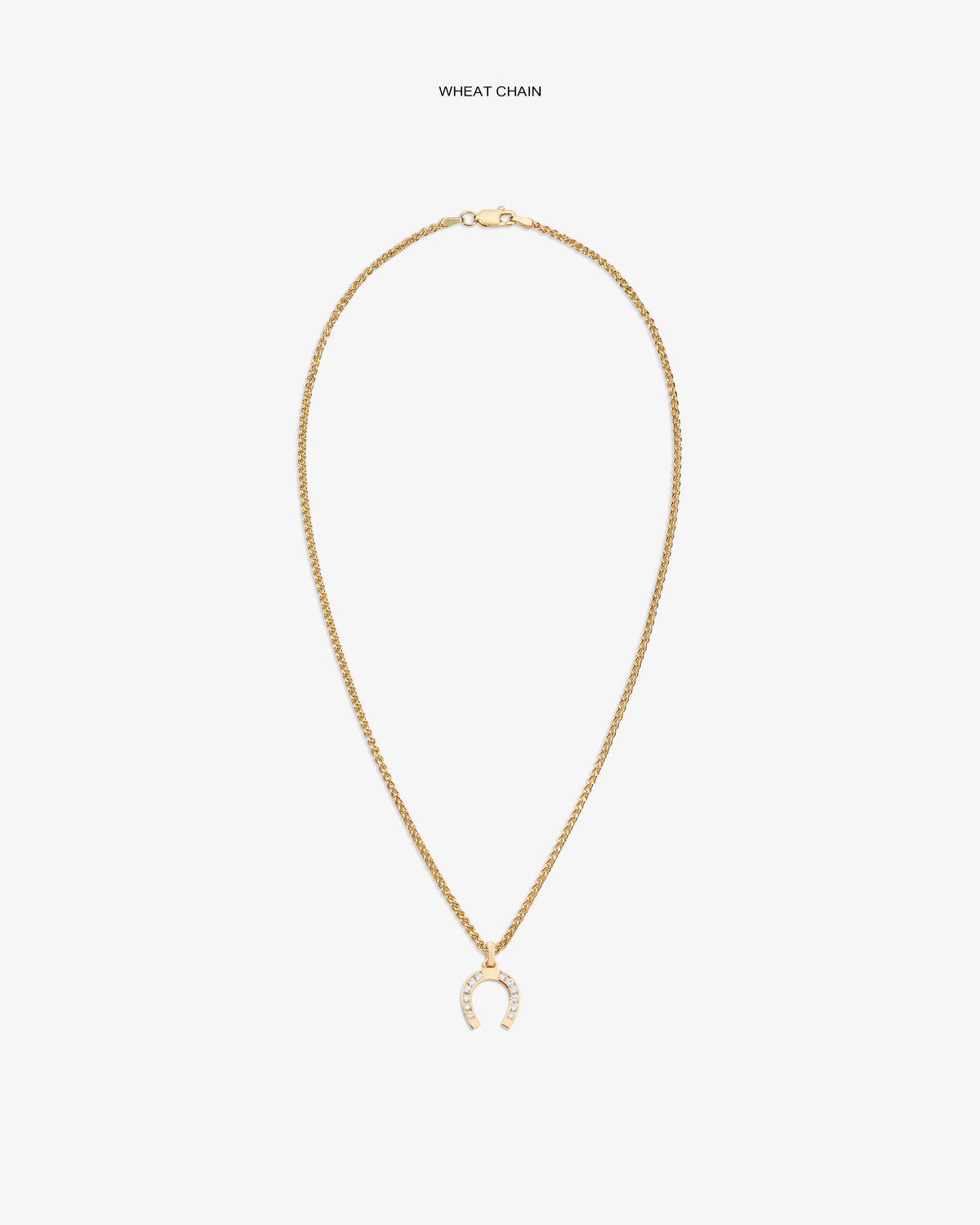 Diamond Horseshoe Pendant on gold wheat chain, shown on white background with sparkling clear stones.
