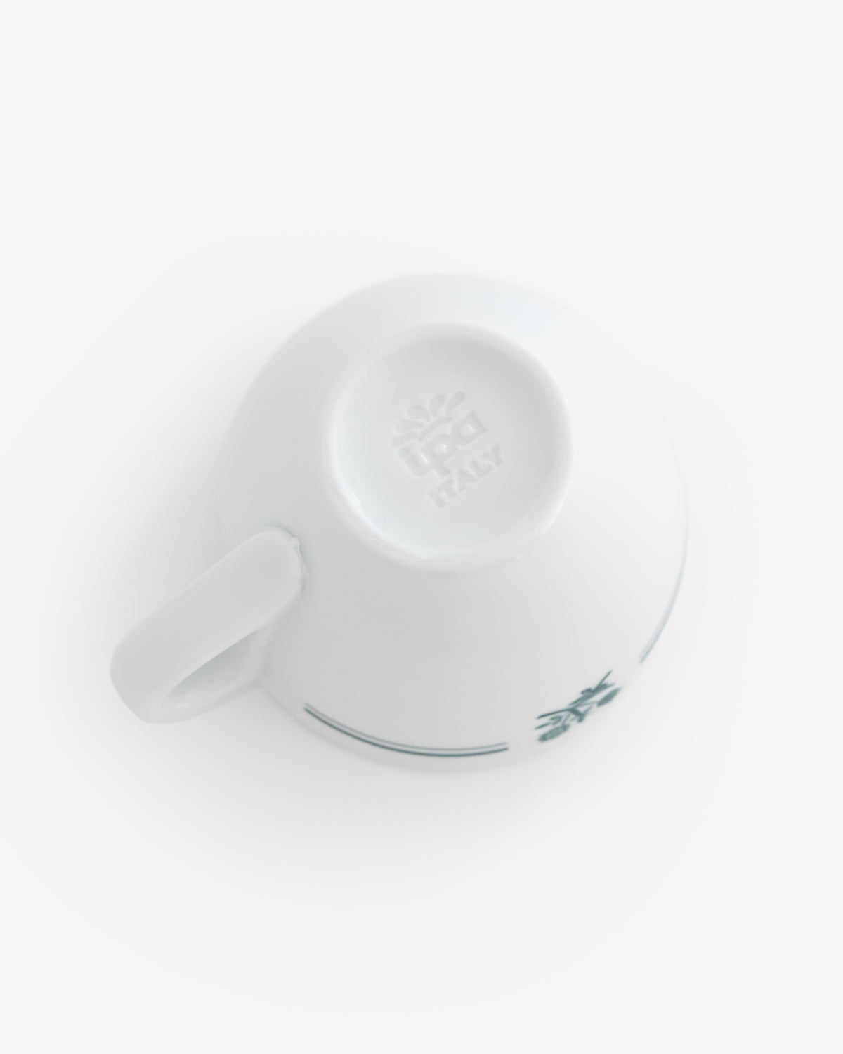 Café Leon Dore Espresso Cup, white porcelain with blue floral patterns and Italy mark, upside down on white background.