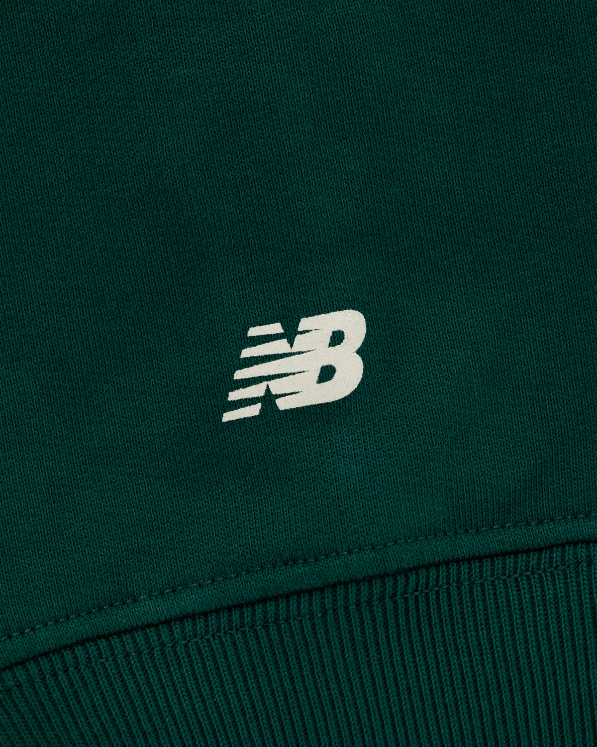 Close-up of the green ALD / New Balance SONNY NY IFTB Crewneck with a white logo at the center.