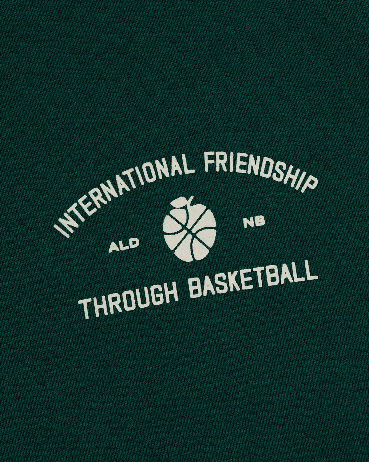 Green ALD/New Balance SONNY NY IFTB Crewneck with white "International Friendship Through Basketball" text graphic.