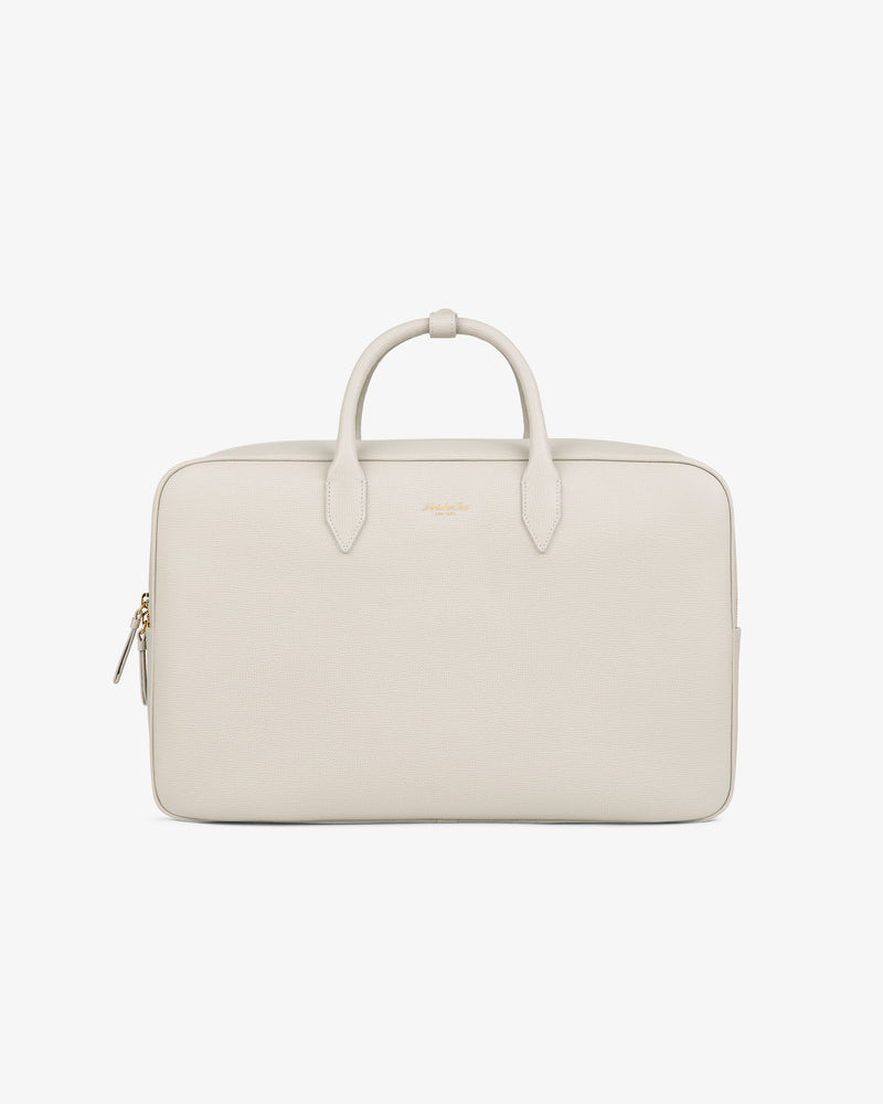 A minimalist Full Grain Leather Briefcase Duffle in light beige with two handles and a gold zipper against a white background.