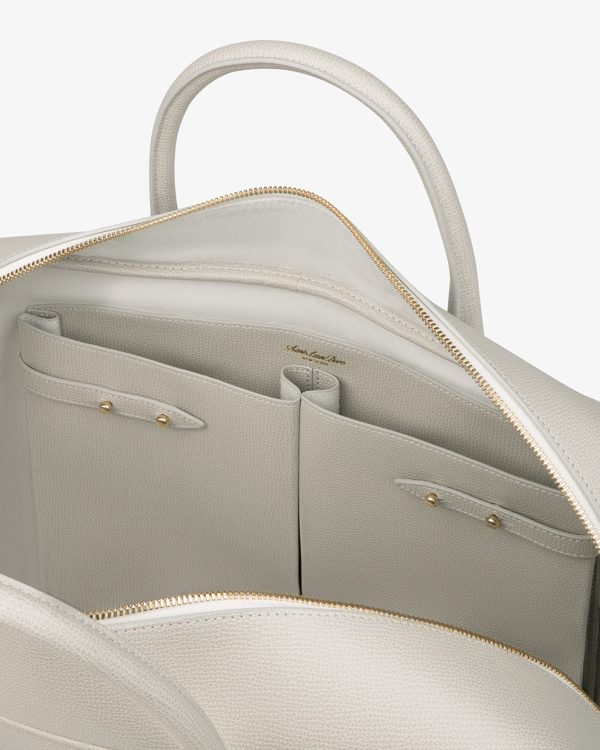 Open Full Grain Leather Briefcase Duffle showing interior pockets and gold zipper on a neutral background.